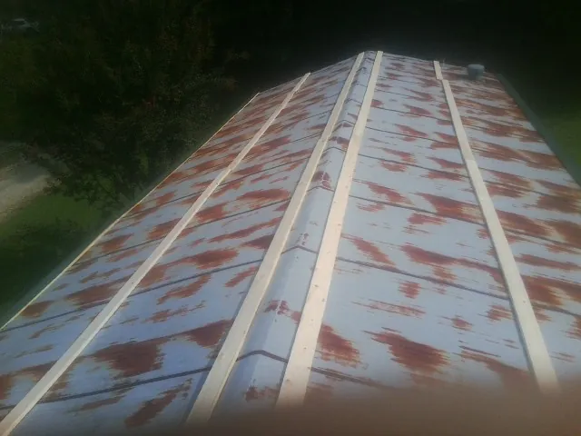 Rusted metal roof panels with new wood purlins before replacement — Storm Damage Roof Repair in Fort Klamath by Roofing Brothers