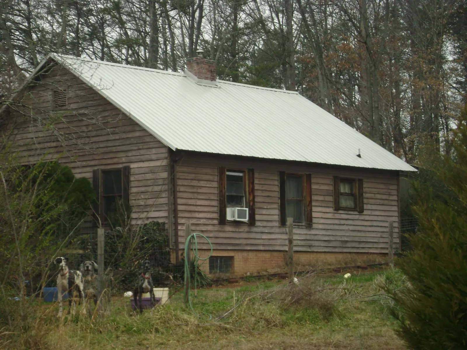 White metal roof on an old wood sided farmhouse, from a Metal Roof Installation job in Fort Klamath